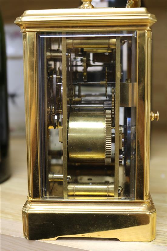 A cased carriage clock and two small lantern clocks